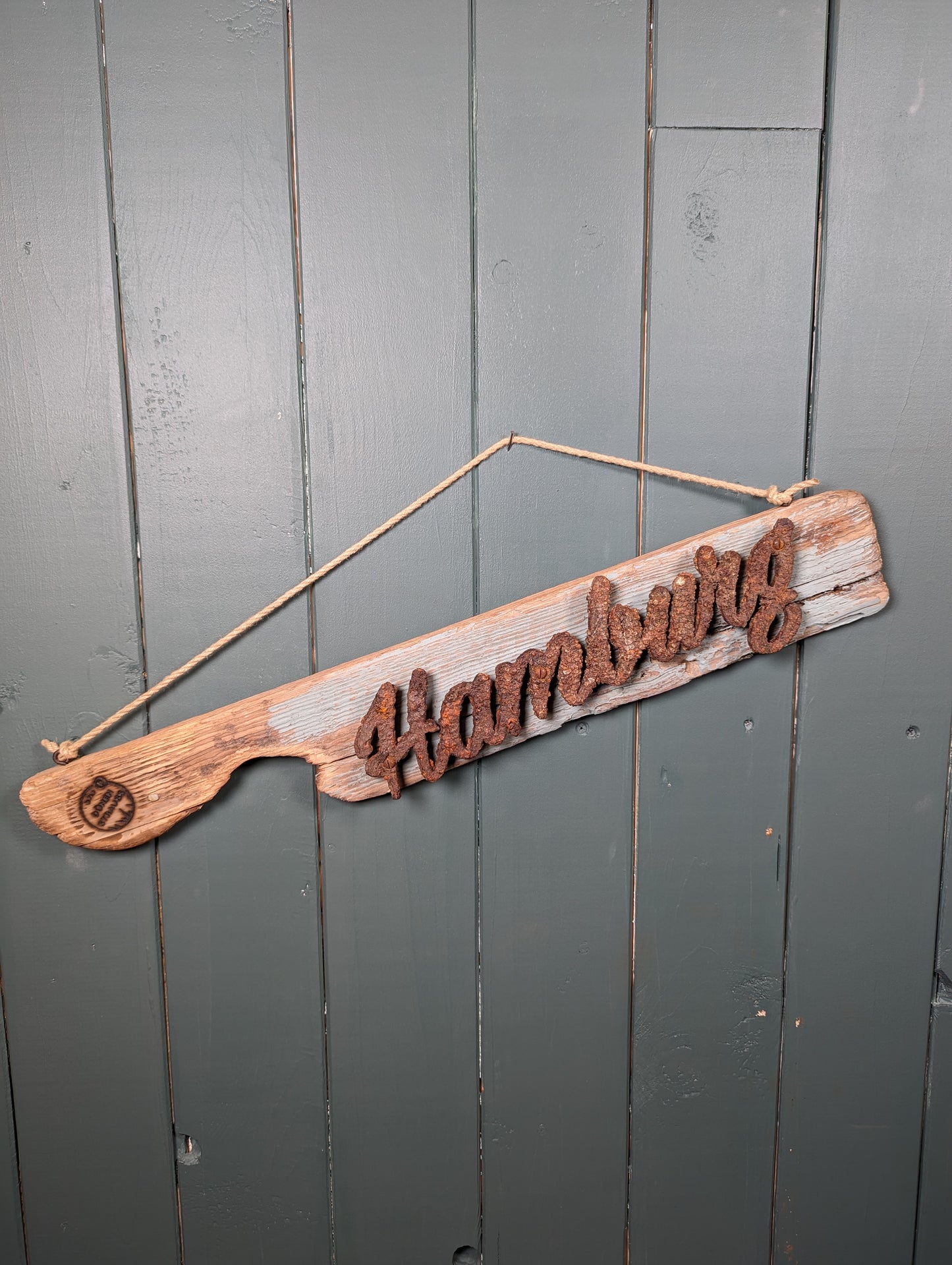 Driftwood-Schild Hamburg mit Seepocken bewachsen